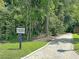 Sidewalk leading to the Riverside Walk, surrounded by mature trees and greenery at 5408 Overland Trl, North Charleston, SC 29420
