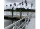 Scenic view of a dock extending into a tranquil lake surrounded by tall pine trees at 552 Richfield Way, Summerville, SC 29486