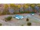 A captivating aerial view of a home featuring a pool and complemented by lush, surrounding trees at 5529 Golden Rice Ln, Ravenel, SC 29470