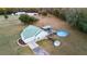 Aerial shot showcasing a home with a new green roof, pool, and deck, featuring a custom outdoor kitchen and gathering space at 5529 Golden Rice Ln, Ravenel, SC 29470