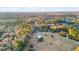 An aerial panorama displays a charming home with a pool, harmoniously integrated within a wooded landscape at 5529 Golden Rice Ln, Ravenel, SC 29470