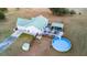 Aerial view of a home with a green roof, a pool and surrounding deck, outdoor kitchen, and spacious backyard at 5529 Golden Rice Ln, Ravenel, SC 29470