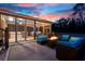 An inviting backyard featuring a fire pit with comfortable seating and a screened-in outdoor kitchen and dining area at 5529 Golden Rice Ln, Ravenel, SC 29470