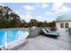 Outdoor oasis featuring a pool, sun loungers, and deck space perfect for relaxation and entertainment at 5529 Golden Rice Ln, Ravenel, SC 29470