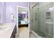 Bathroom featuring a tiled shower with glass doors and a purple painted room at 5529 Golden Rice Ln, Ravenel, SC 29470
