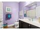 Bathroom featuring a sink with black cabinetry, purple walls and a toilet at 5529 Golden Rice Ln, Ravenel, SC 29470
