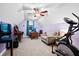 Upstairs bedroom with ceiling fan, large windows, and exercise equipment at 5529 Golden Rice Ln, Ravenel, SC 29470