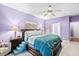 Bedroom showcasing purple walls and a dark wood bed frame with a furry teal blanket at 5529 Golden Rice Ln, Ravenel, SC 29470