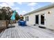 Spacious wooden deck featuring an umbrella, outdoor dining set and access to the home's interior at 5529 Golden Rice Ln, Ravenel, SC 29470