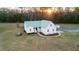 New construction home with a light green roof, white siding, manicured lawn, and well-maintained landscaping at 5529 Golden Rice Ln, Ravenel, SC 29470