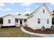 A beautifully landscaped front yard leads to this inviting home featuring a metal roof at 5529 Golden Rice Ln, Ravenel, SC 29470