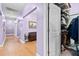 View of hallway with hardwood flooring, purple walls and a walk-in closet at 5529 Golden Rice Ln, Ravenel, SC 29470