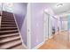 Hallway with hardwood floors and staircase to the second floor at 5529 Golden Rice Ln, Ravenel, SC 29470