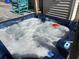 Close up of a relaxing hot tub with turquoise rocking chairs nearby at 5529 Golden Rice Ln, Ravenel, SC 29470
