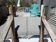 Outdoor hot tub on wooden deck with patio furniture, umbrella, and privacy, perfect for relaxing or entertaining at 5529 Golden Rice Ln, Ravenel, SC 29470