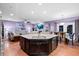 Spacious kitchen with granite counters and adjacent living and dining areas at 5529 Golden Rice Ln, Ravenel, SC 29470