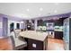 Kitchen island with sink and granite countertop, stainless steel appliances, and barstool seating at 5529 Golden Rice Ln, Ravenel, SC 29470