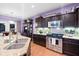 Stainless steel oven, cooktop, microwave, and tile backsplash in modern kitchen at 5529 Golden Rice Ln, Ravenel, SC 29470