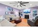 The living room features a cozy fireplace, hardwood floors, and a comfortable sectional sofa at 5529 Golden Rice Ln, Ravenel, SC 29470