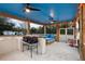 Covered patio featuring ceiling fans, a grilling station, and ample seating, perfect for outdoor entertaining at 5529 Golden Rice Ln, Ravenel, SC 29470
