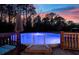 The above ground pool features a deck and an umbrella, perfect for summertime relaxation at 5529 Golden Rice Ln, Ravenel, SC 29470