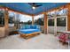 Relaxing screened-in porch with cozy daybed and ceiling fan providing a comfortable outdoor living space at 5529 Golden Rice Ln, Ravenel, SC 29470