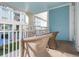 Cozy balcony featuring comfortable wicker chairs and a view of the manicured grounds and colorful building exterior at 5804 Palmetto Dr # A-208, Isle of Palms, SC 29451