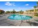 A large luxurious pool surrounded by lounge chairs, umbrellas, and lush landscaping offers a relaxing resort experience at 5804 Palmetto Dr # A-208, Isle of Palms, SC 29451