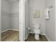 Bathroom featuring a toilet, towel rack and framed wall art with wood-style vinyl flooring at 60 Fenwick Hall Allee # 728, Johns Island, SC 29455