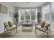 Cozy living room with large windows, bright decor, and vinyl wood-style flooring at 60 Fenwick Hall Allee # 728, Johns Island, SC 29455