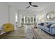 Bright living room with large window, stylish furniture, and modern ceiling fan at 60 Fenwick Hall Allee # 728, Johns Island, SC 29455