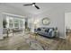 Bright living room with large window, stylish furniture, and modern ceiling fan at 60 Fenwick Hall Allee # 728, Johns Island, SC 29455