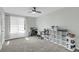 Bright bedroom features a ceiling fan, neutral paint, large window and shelving unit for ample storage at 6244 Lucille Dr # B, North Charleston, SC 29406