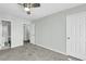 Carpeted bedroom featuring neutral walls, a ceiling fan, and white doors to the bathroom and closets at 6244 Lucille Dr # B, North Charleston, SC 29406