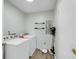 Well-organized laundry room with washer, dryer, and convenient storage shelves at 6244 Lucille Dr # B, North Charleston, SC 29406