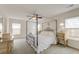 A beautifully staged primary bedroom boasts a canopy bed and relaxing ambiance at 7034 Lanier St, Hanahan, SC 29410