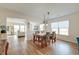 Open-concept dining room with hardwood floors and a decorative chandelier at 7034 Lanier St, Hanahan, SC 29410