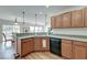 Modern kitchen with hardwood floors, black appliances, sleek counter tops, and functional layout at 7034 Lanier St, Hanahan, SC 29410