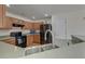 Well-lit kitchen features wood cabinetry and modern black appliances, including range and refrigerator at 7034 Lanier St, Hanahan, SC 29410