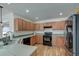 Functional kitchen with stainless steel appliances and wood cabinetry at 7034 Lanier St, Hanahan, SC 29410