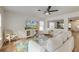 Bright living room with a modern ceiling fan, TV, and rug with floral pattern at 7034 Lanier St, Hanahan, SC 29410