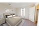 Bedroom boasts a tufted headboard, neutral decor, and a window for natural light at 744 Pisces Ln, Summerville, SC 29486