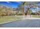 Spacious backyard view from the gray wooden deck with white railing at 7461 Church Hill Rd, Hollywood, SC 29449
