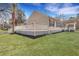 Beautiful home exterior with an expansive white wooden deck and lush green lawn at 7461 Church Hill Rd, Hollywood, SC 29449