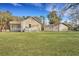Expansive backyard featuring a well-maintained lawn and a detached garage, perfect for outdoor activities and storage at 7461 Church Hill Rd, Hollywood, SC 29449