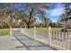 Backyard view from the gray wooden deck with white railing under a blue sky at 7461 Church Hill Rd, Hollywood, SC 29449