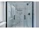 Elegant glass-door shower with marble tile design and chrome fixtures at 7461 Church Hill Rd, Hollywood, SC 29449