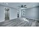 Spacious bedroom with gray walls, ceiling fan, and wood-look floors at 7461 Church Hill Rd, Hollywood, SC 29449