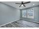 Bright bedroom with two windows and a ceiling fan, providing natural light and comfort at 7461 Church Hill Rd, Hollywood, SC 29449