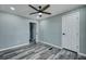 Bedroom with gray walls, wood-look flooring, ceiling fan, and a white door at 7461 Church Hill Rd, Hollywood, SC 29449